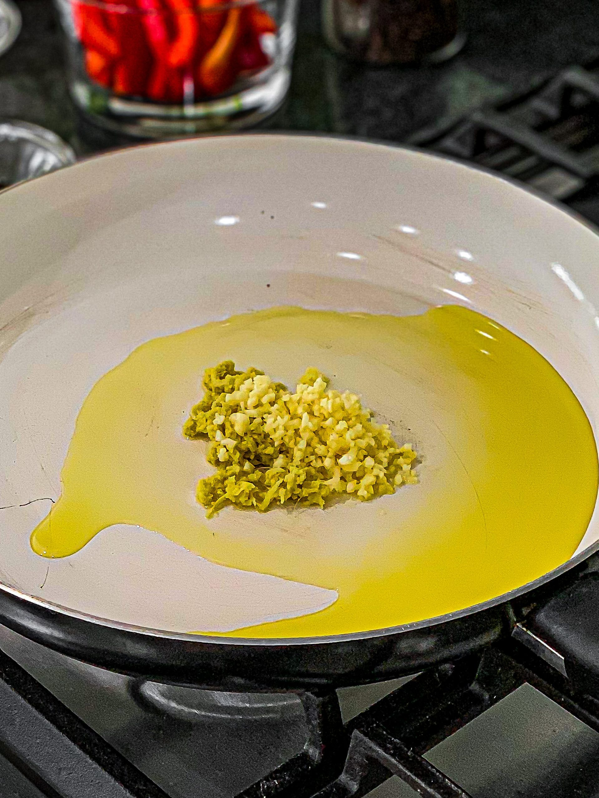 In a large skillet add olive oil and heat to medium-low. Add the garlic and ginger and cook for 30 seconds or until garlic is golden.