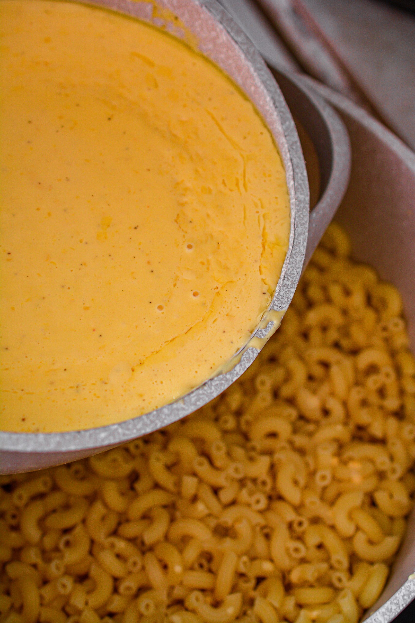 Pour the cheese mixture over the macaroni in a large saucepan.