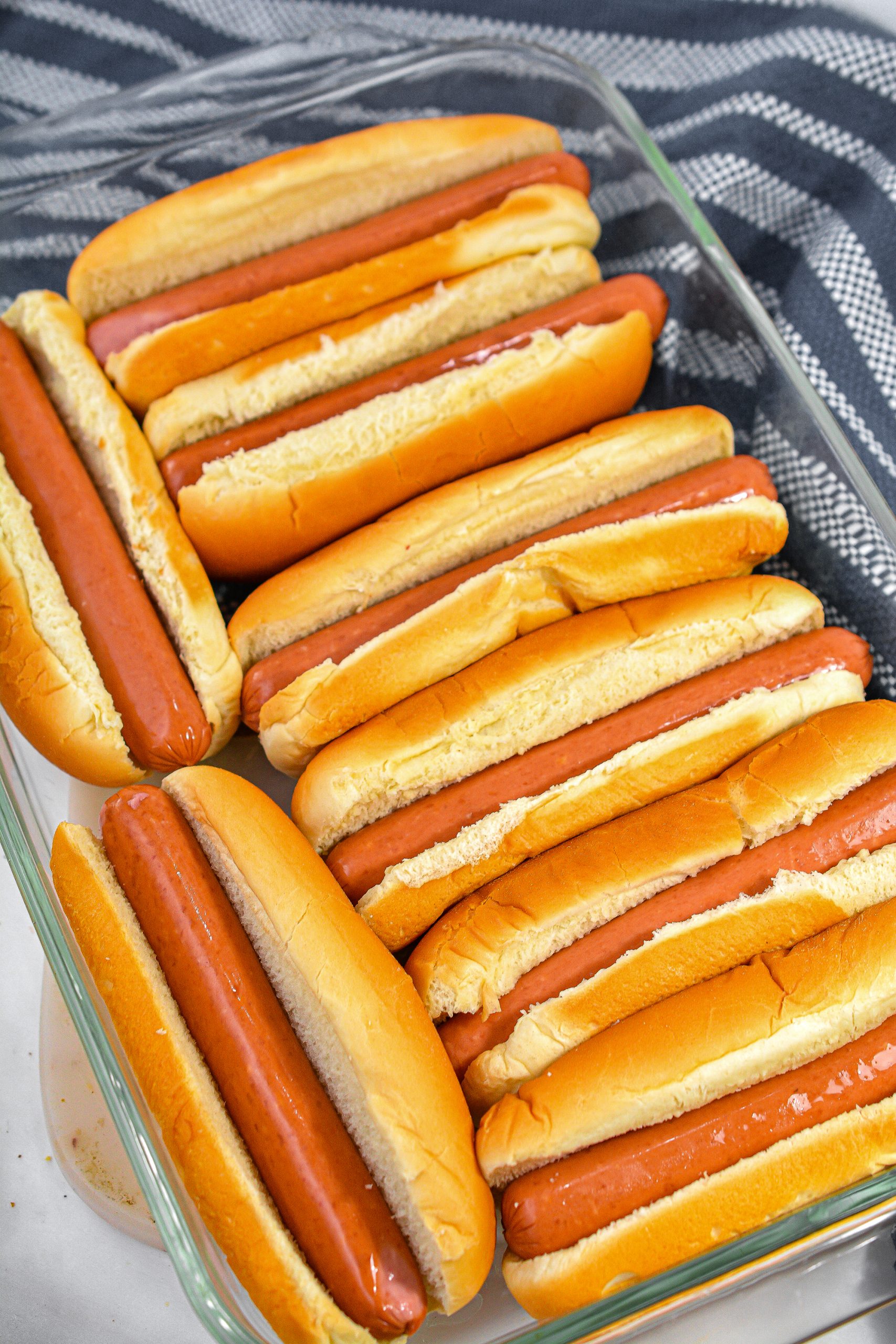 Add a hot dog to each bun.