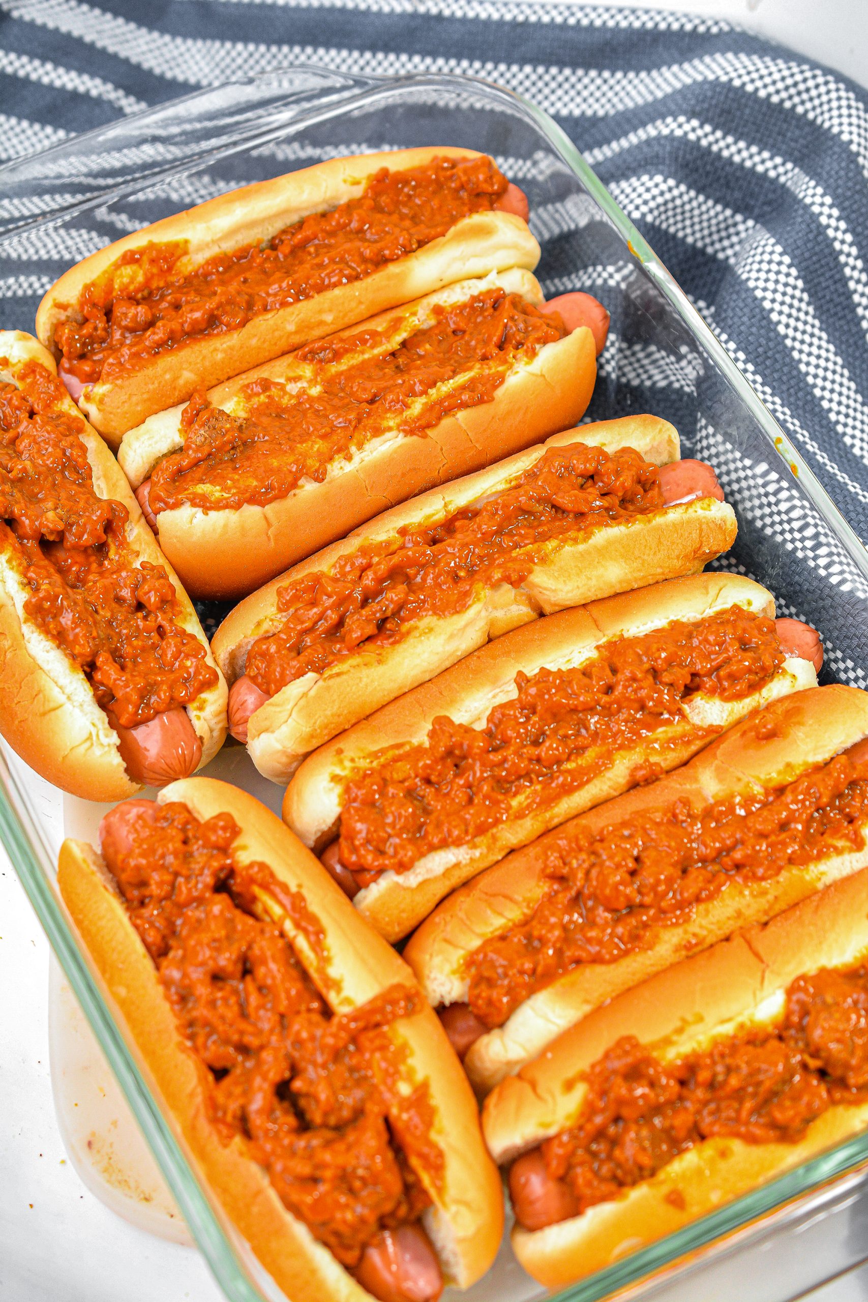 Top each hot dog with a serving of chili.