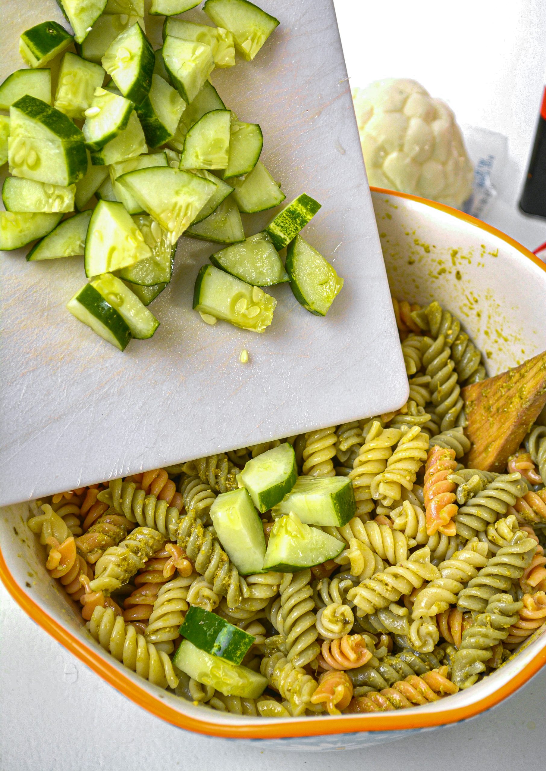 Add one chopped cucumber to the pasta.