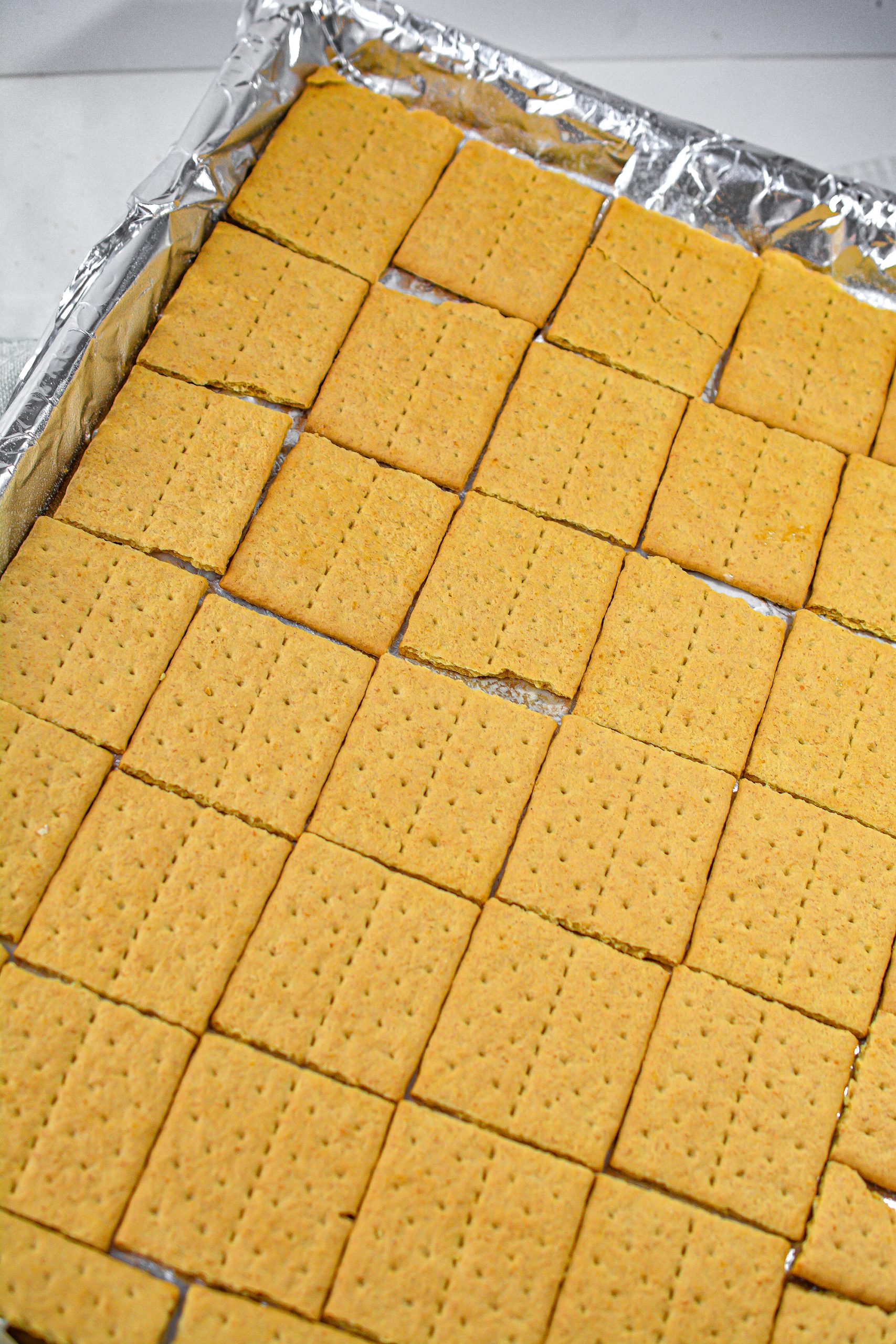Spread the graham cracker squares in a solid layer on the baking sheet.