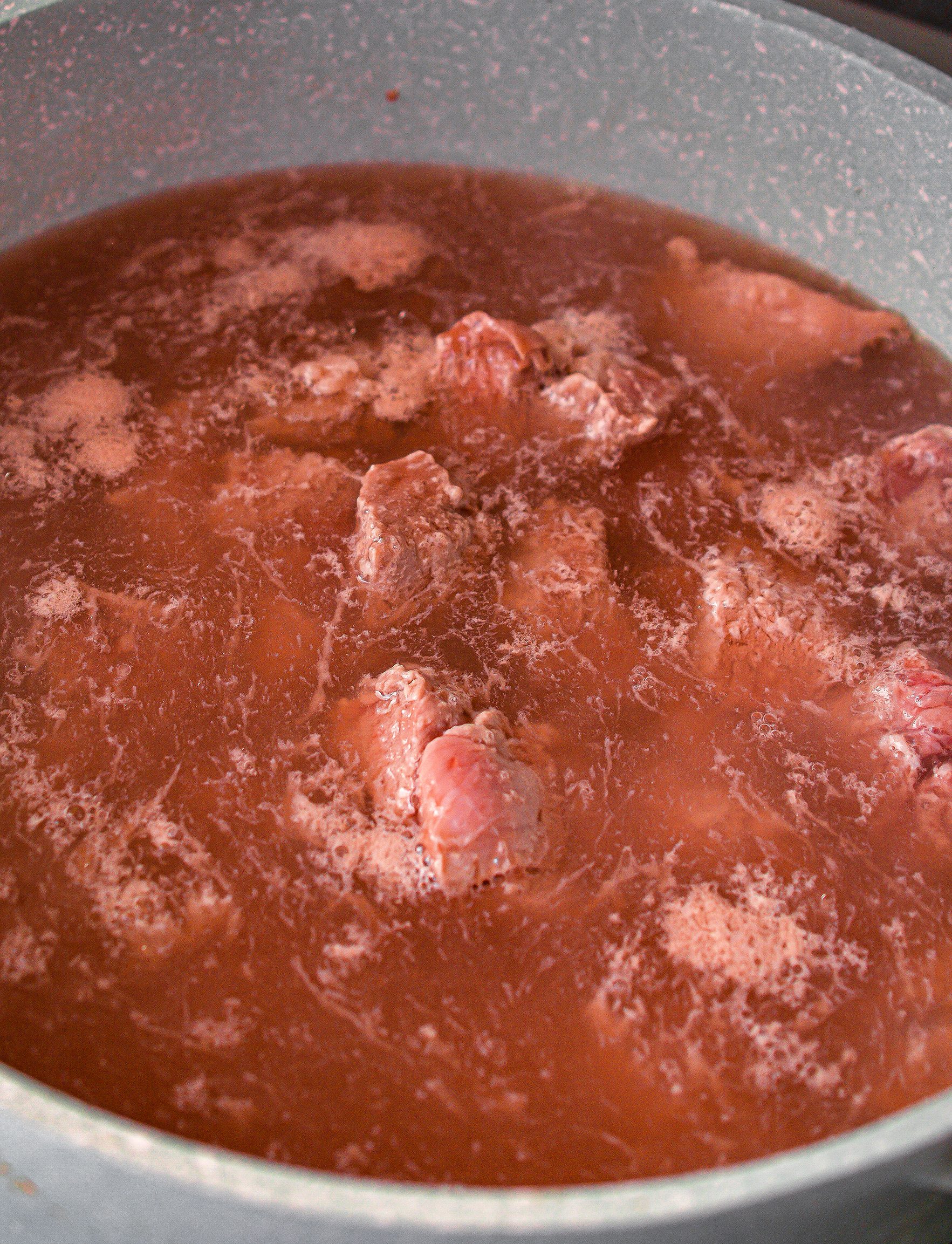  Place the beef into a pot and cover with water.