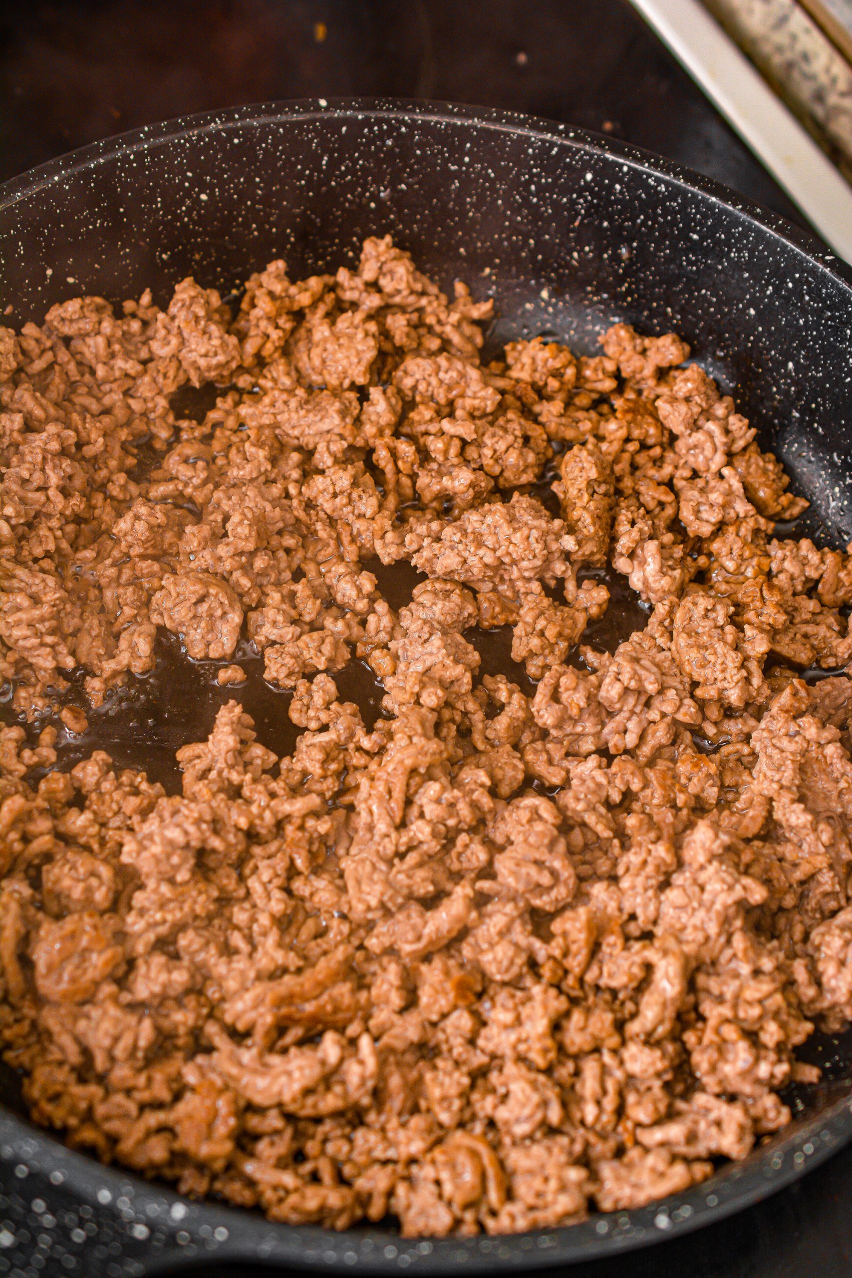 Cook the beef in a skillet over medium-high heat until browned completely. Set aside.