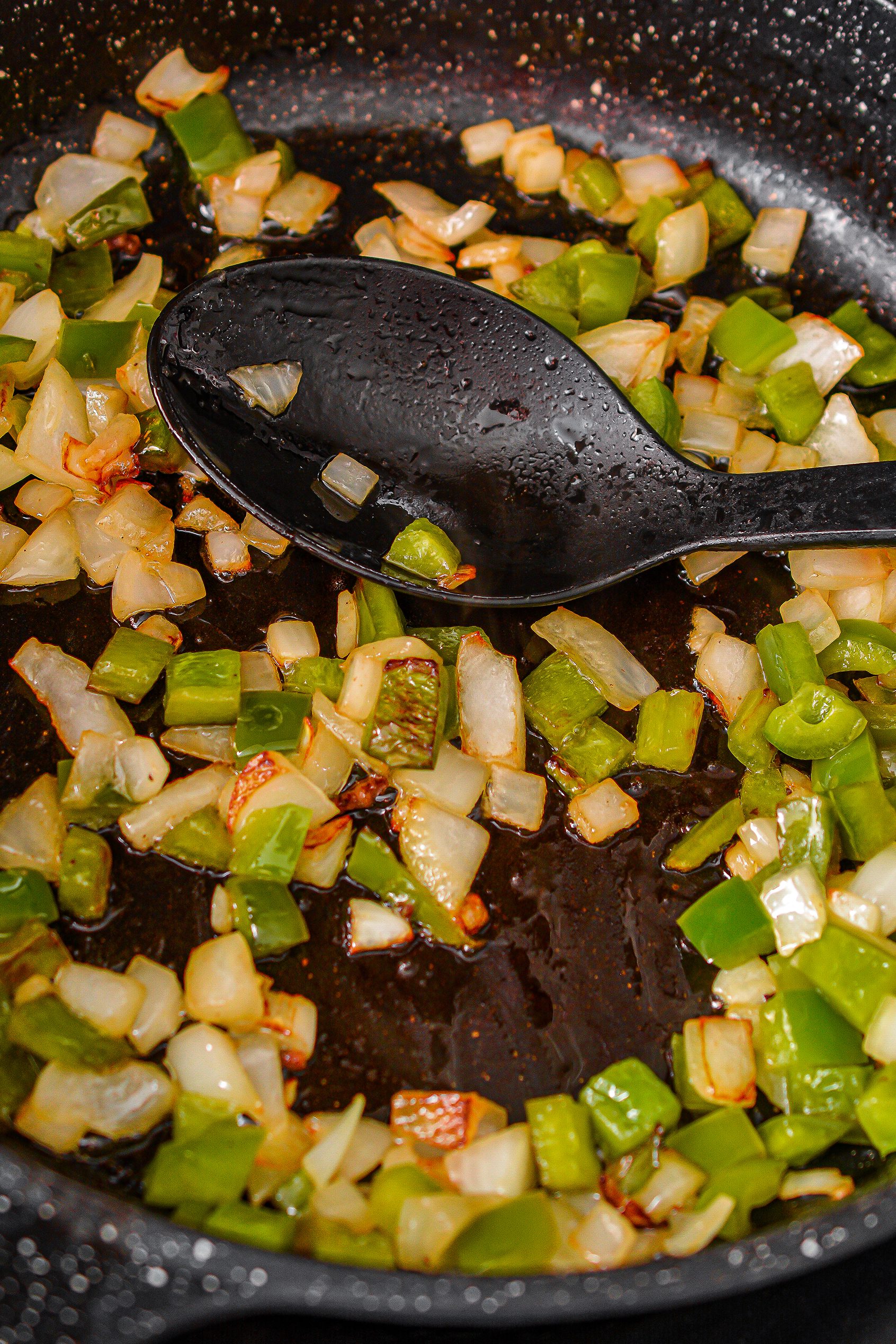 Add the butter, onion, and pepper to the skillet and cook until they begin to soften.