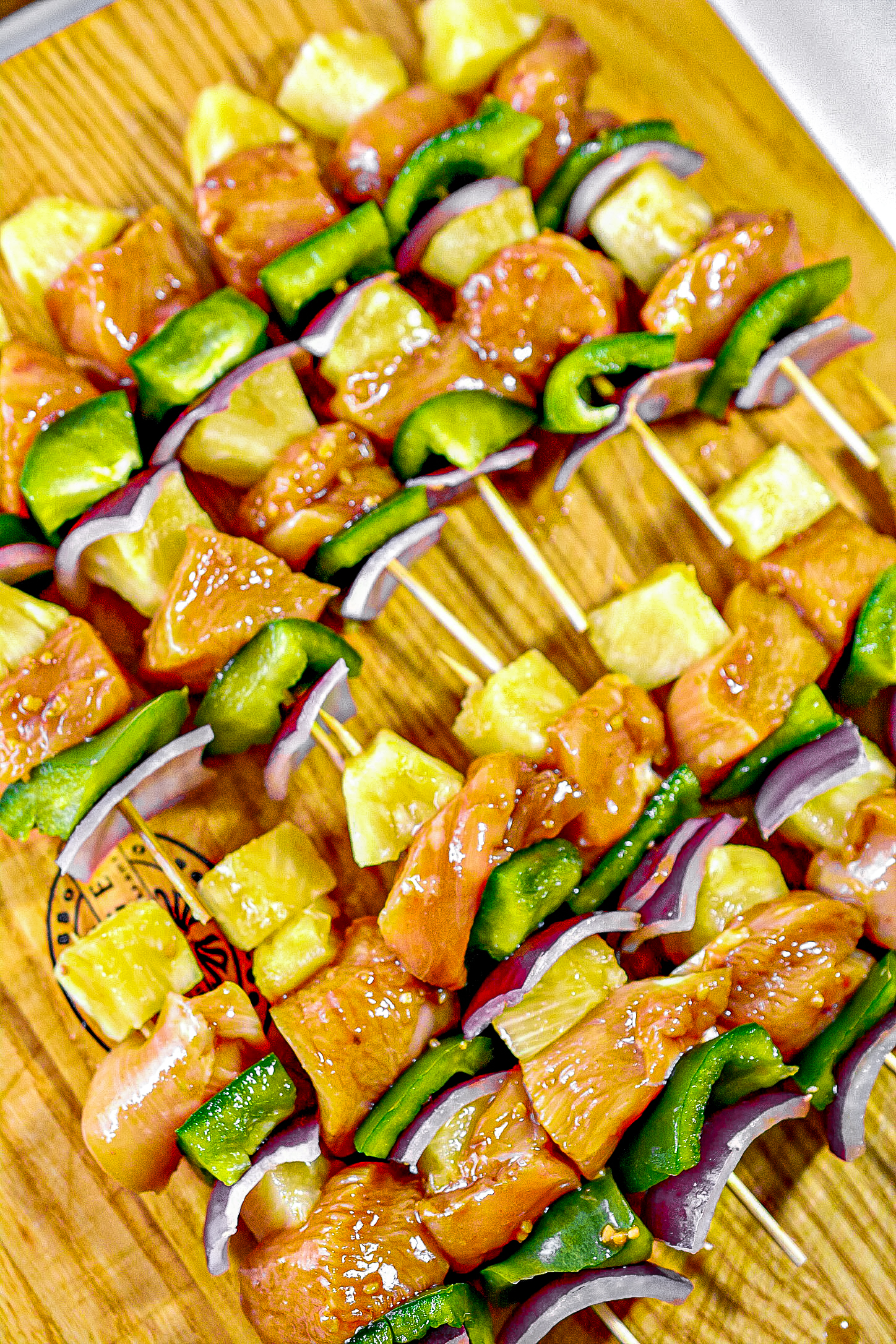 Fill the skewers with chunks of onion, pepper, the marinated chicken and pineapple chunks.