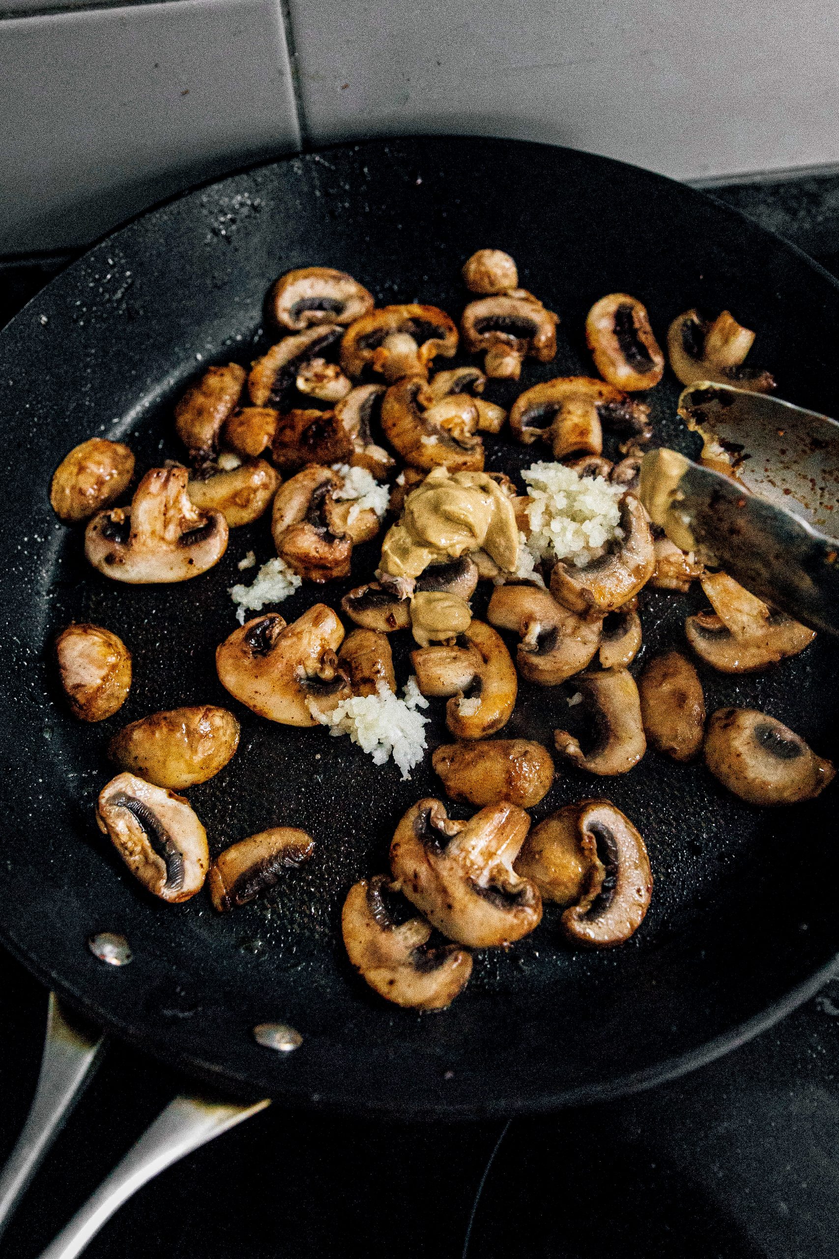 In the same skillet, melt remaining butter over medium-high heat. You are going to add in your mushrooms and cook until the excess moisture evaporates and until they are golden.