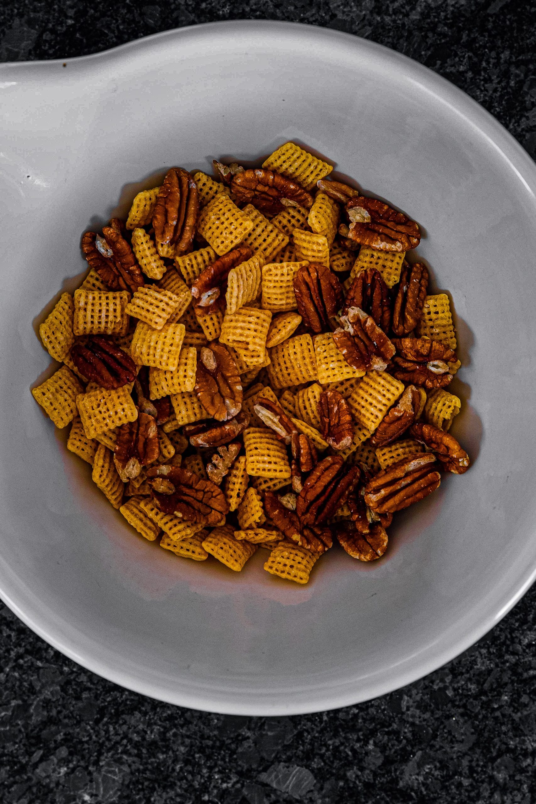 Combine cereal (or Corn Chex) and unsalted pecans.