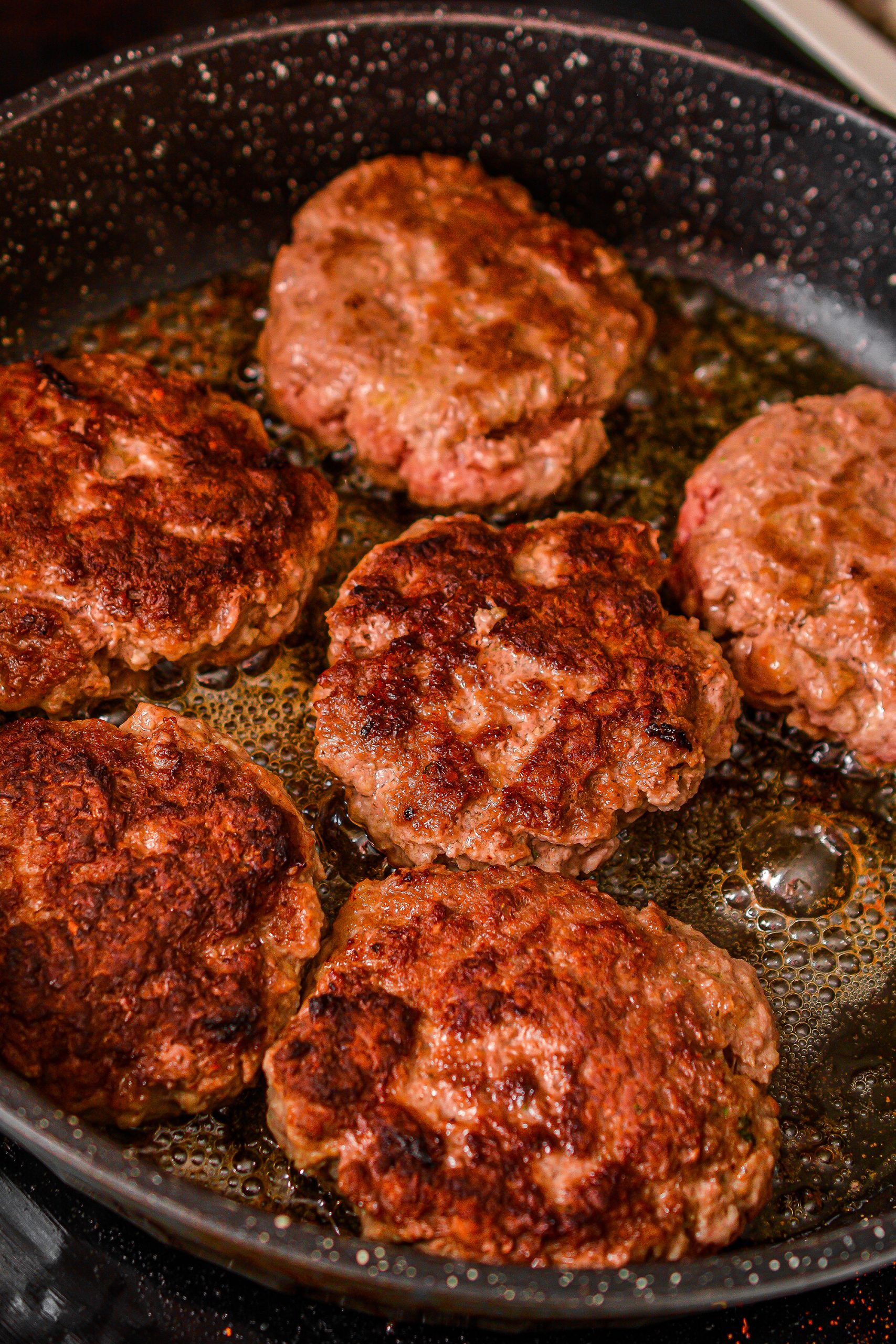 Pour the soup mixture over the browned patties in the skillet, reduce the heat to medium or medium-low, and simmer for 20 minutes covered.