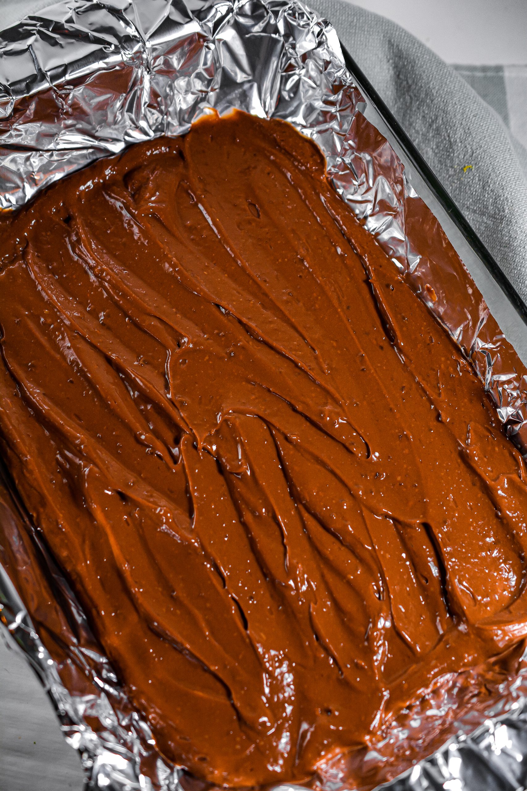 Layer the chocolate pudding evenly in the bottom of the baking dish.