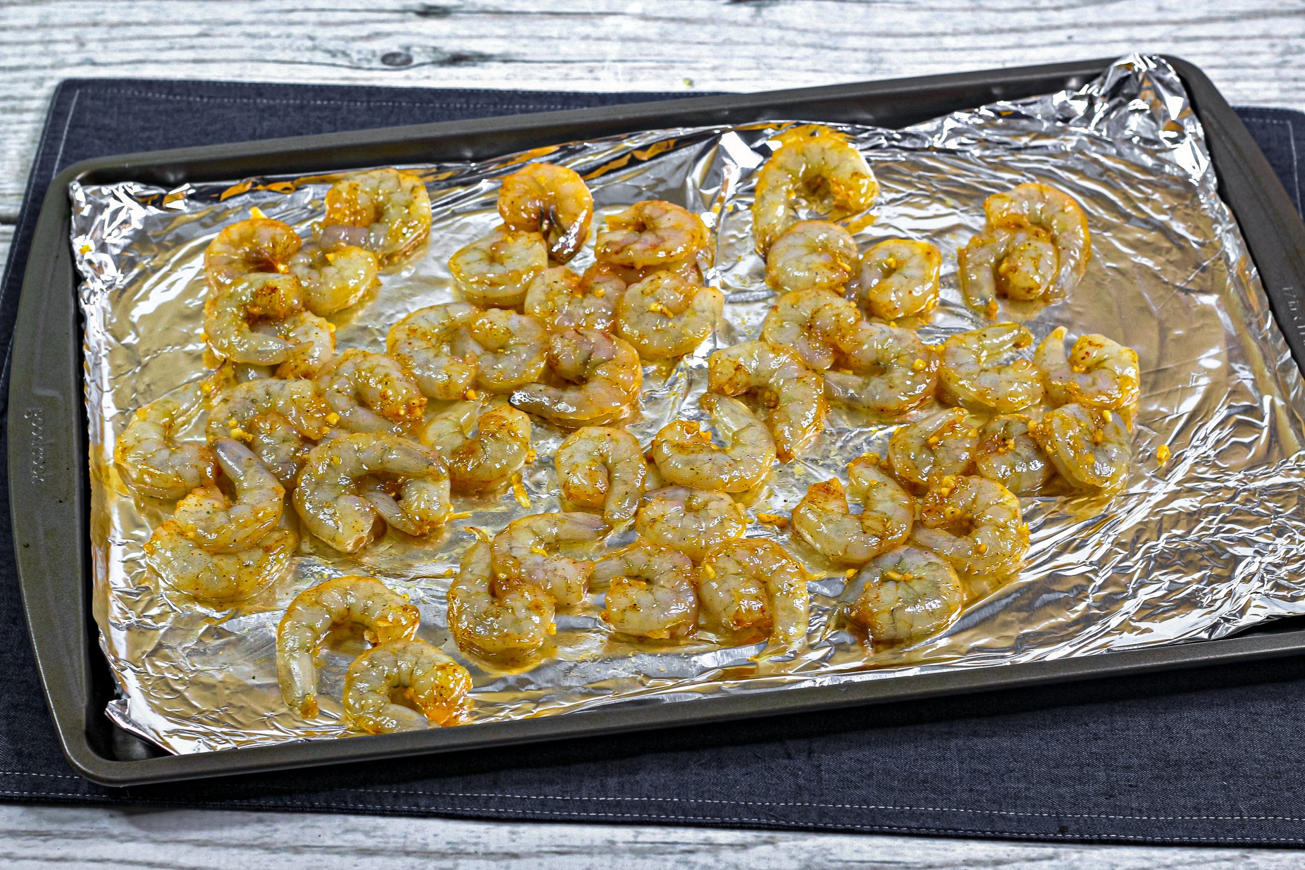 Line a baking tray with foil and evenly lay your shrimp on top.