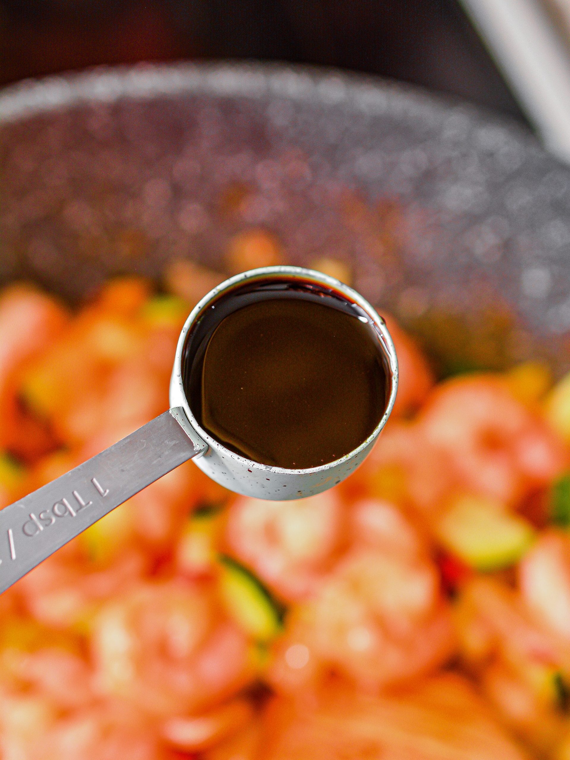 Place the shrimp bag in the skillet, and pour in the chili sauce as well as the soy sauce.