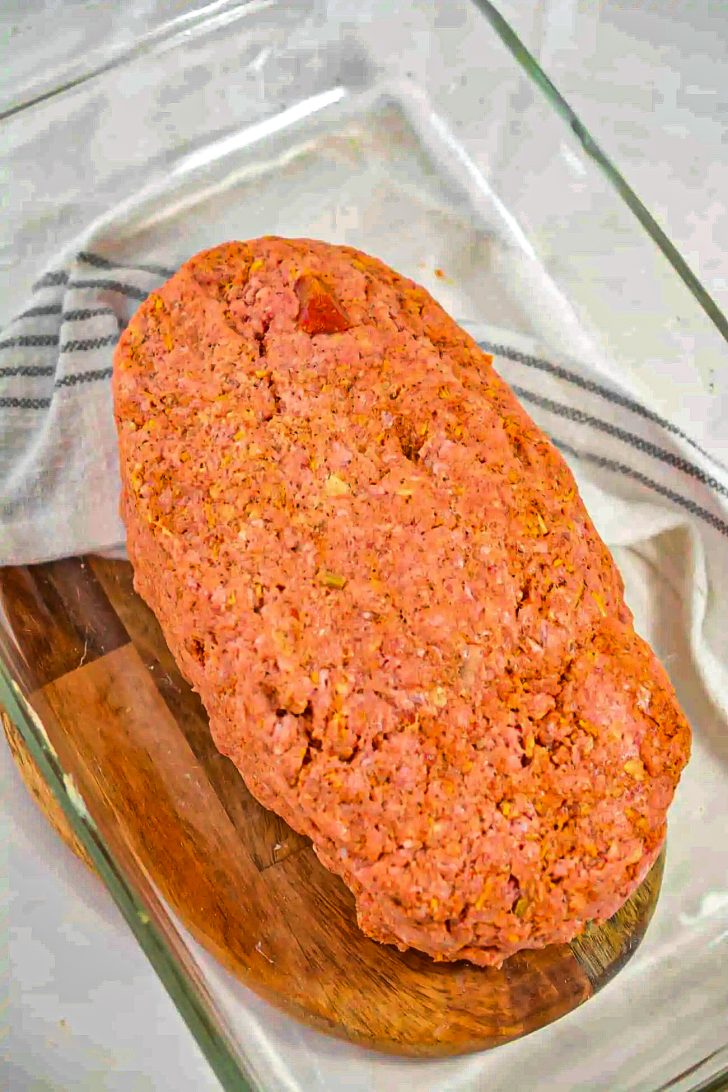 Form the meat mixture into a loaf shape, and place into a 9x13 baking dish.