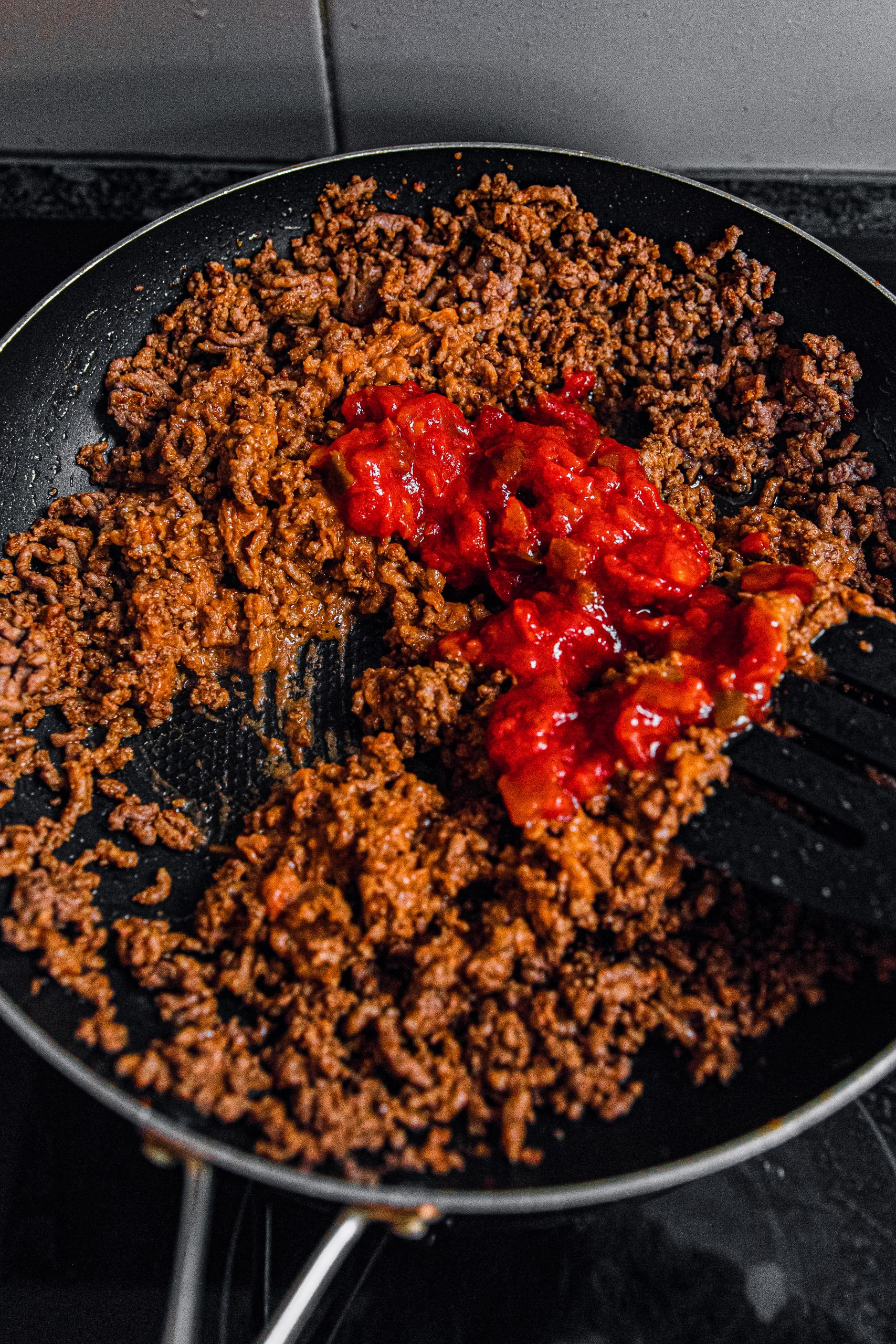 Remove any excess fat then mix in taco seasoning, salsa, and refried beans.