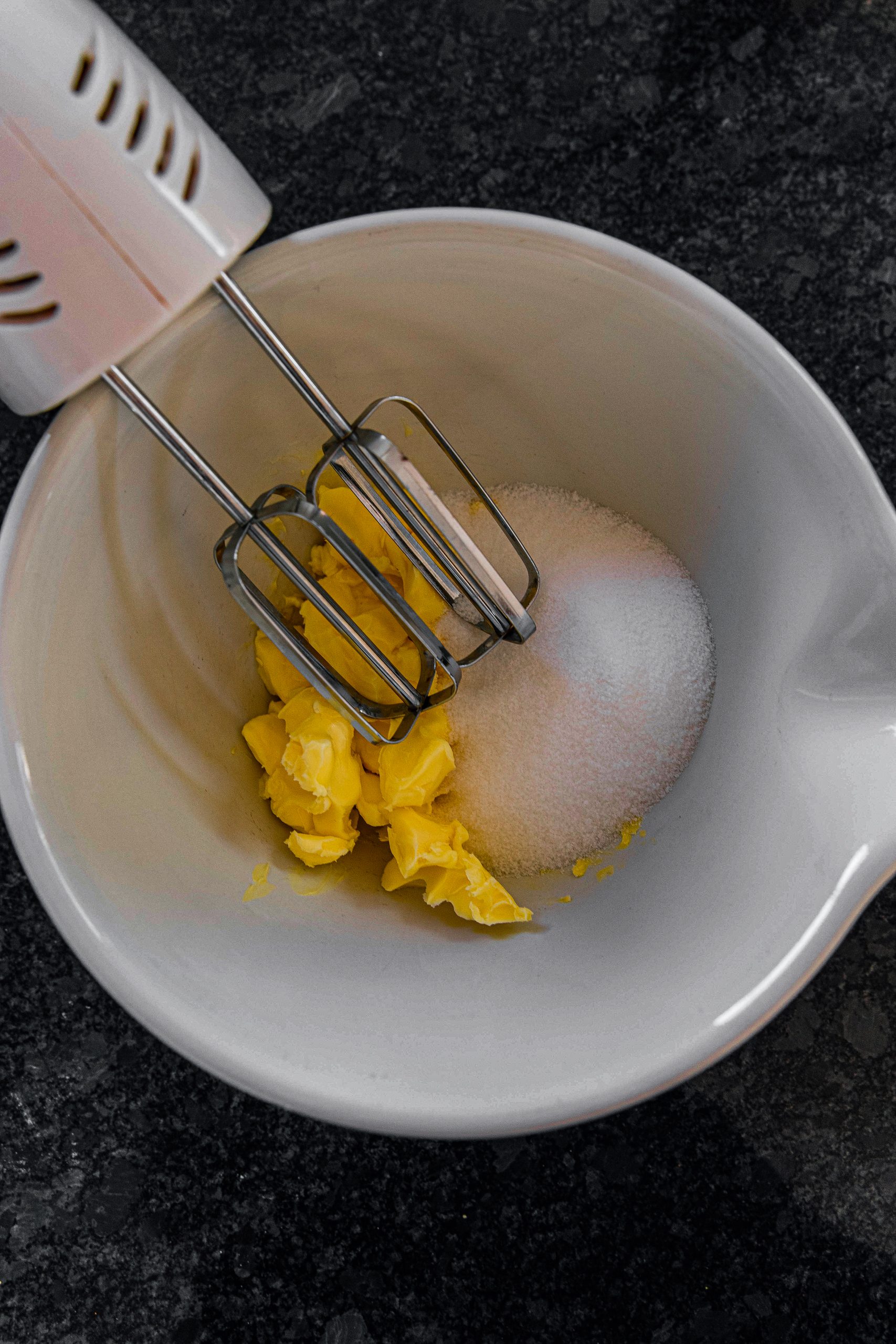 Add a ½ cup of butter and 1 cup of raw sugar in a medium mixing bowl. Using an electric mixer, mix it until it’s creamy. 