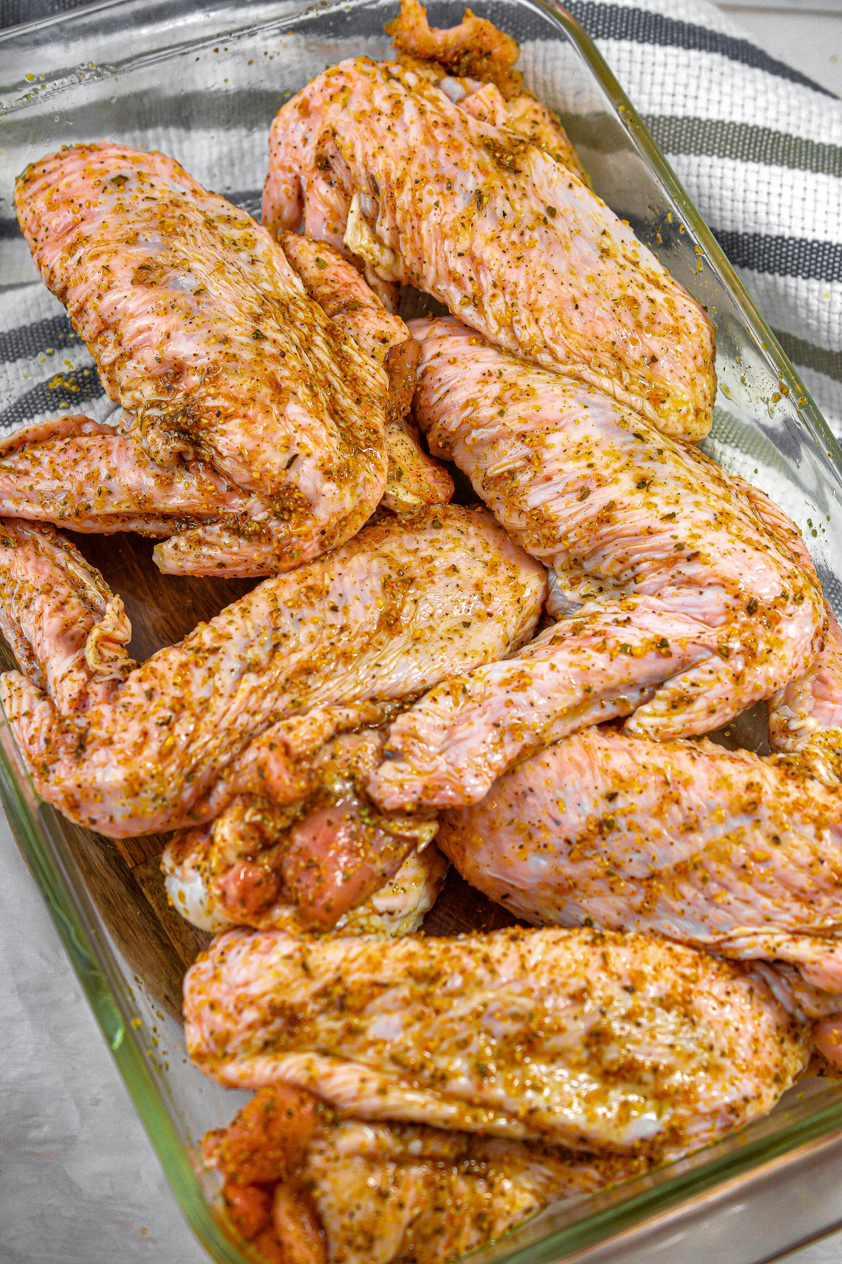 Place the wings into a 9x13 casserole dish or roasting pan and cover with aluminium foil.