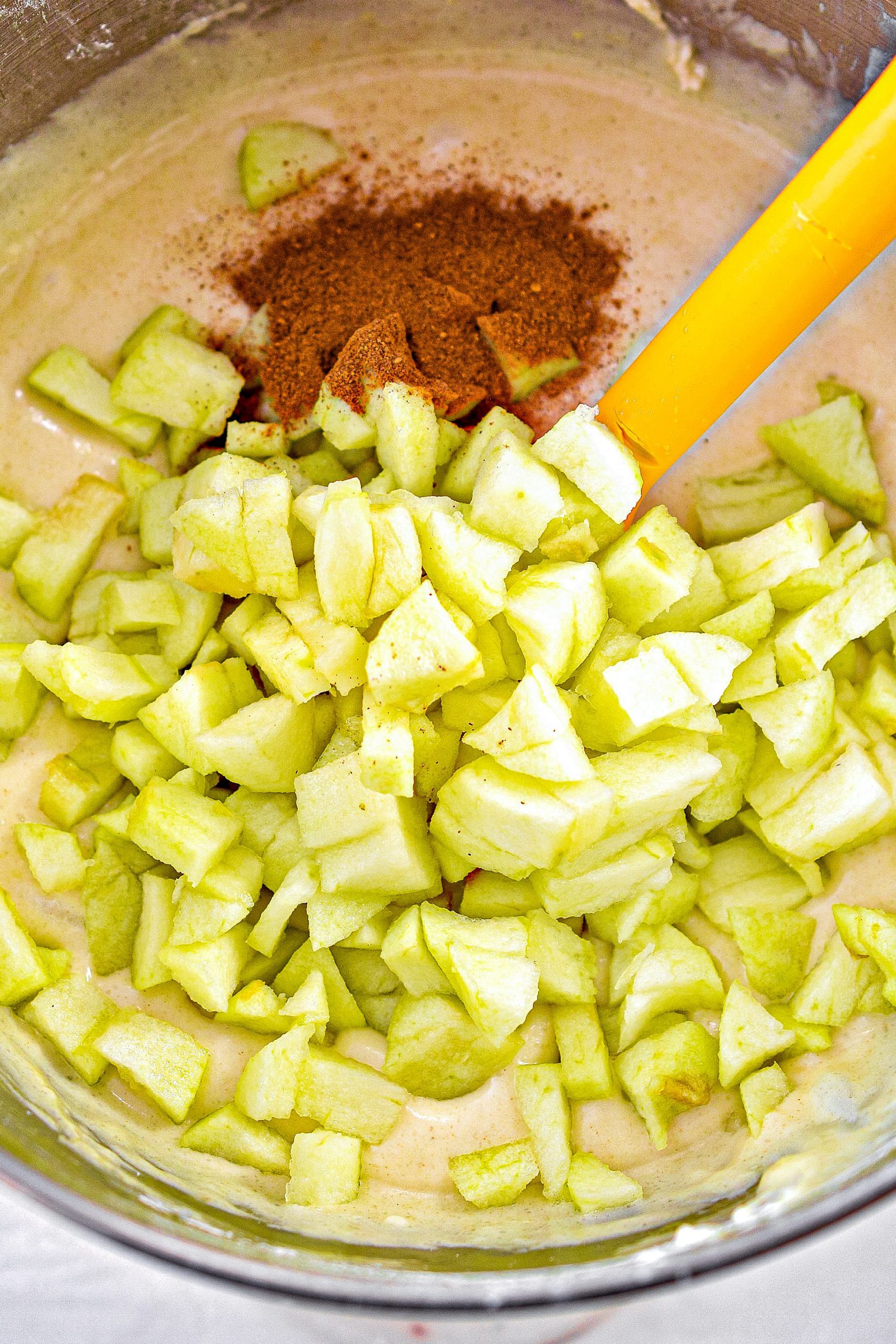 Fold in the apples and apple pie spice until well incorporated.
