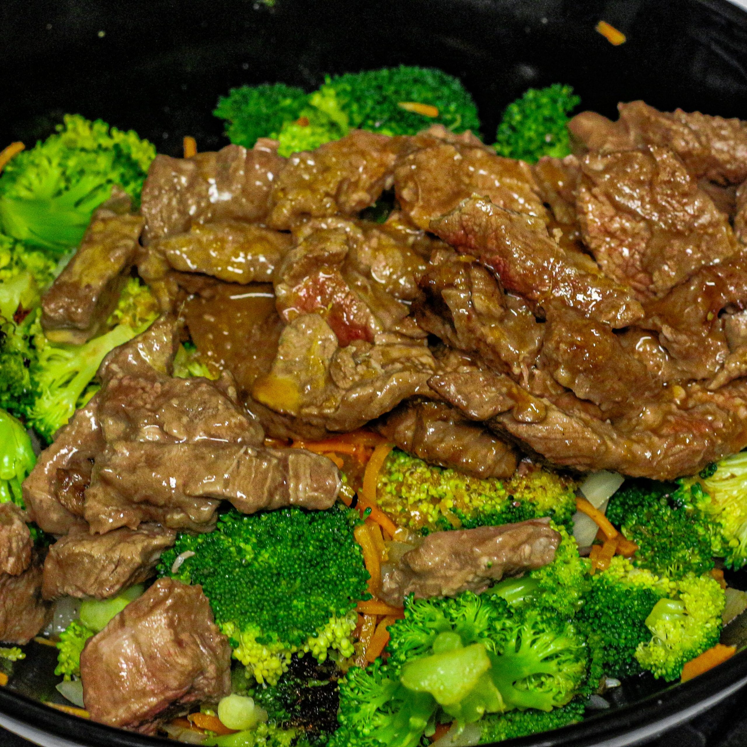 Stir-fry broccoli, carrots, and onion in the remaining oil. Add the beef and sauce.