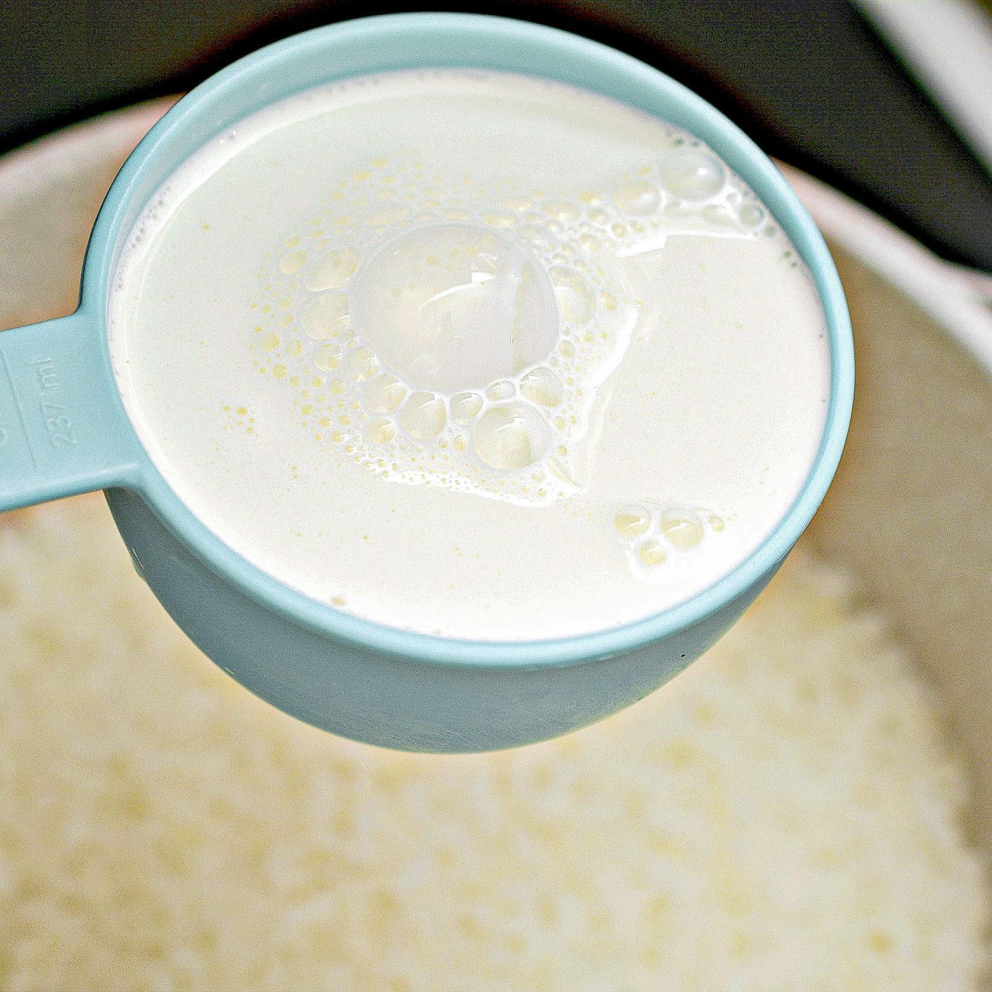 Add the butter to the cooked rice, and mix in the half and half, ½ cup of the milk, sugar, and salt.