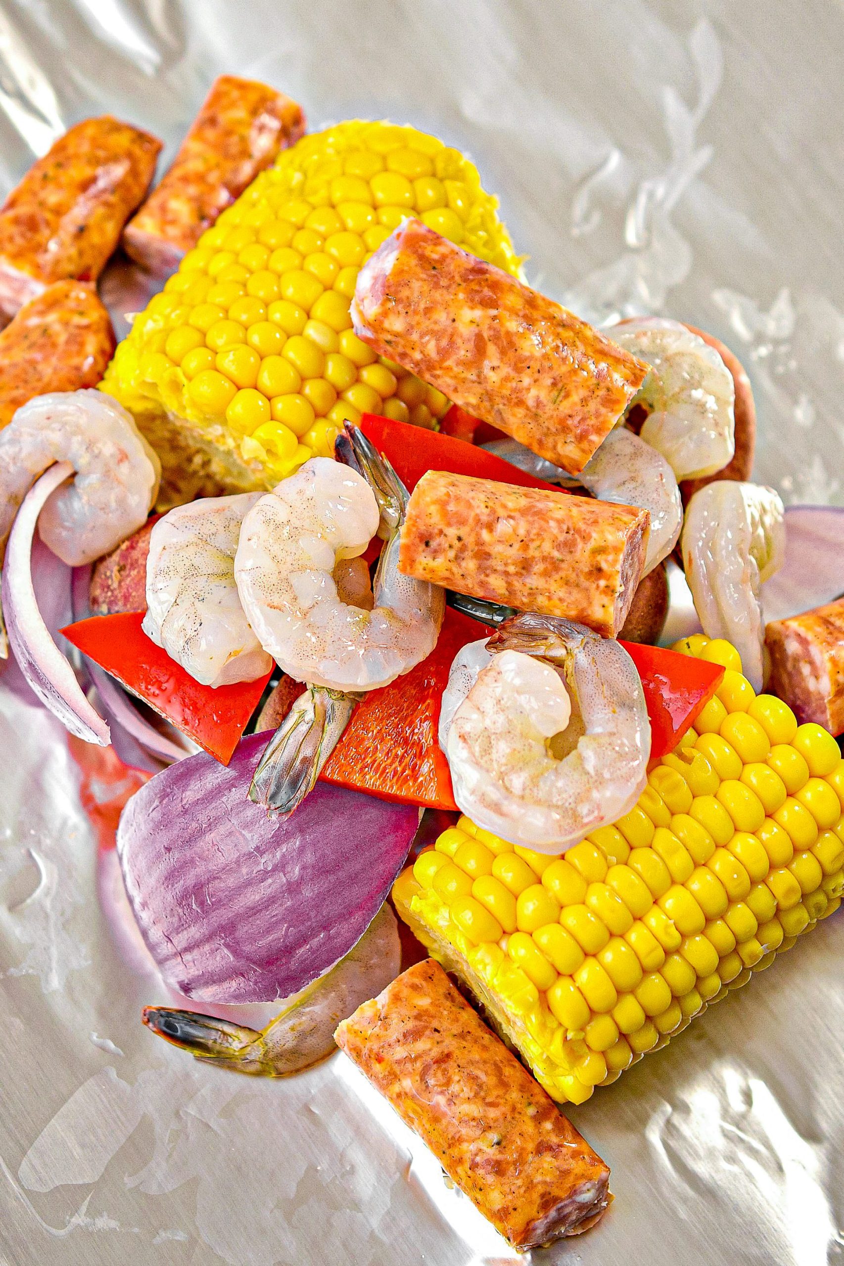 add shrimp, sausage, red bell pepper, salt, and pepper to taste, and cajun seasoning to taste.