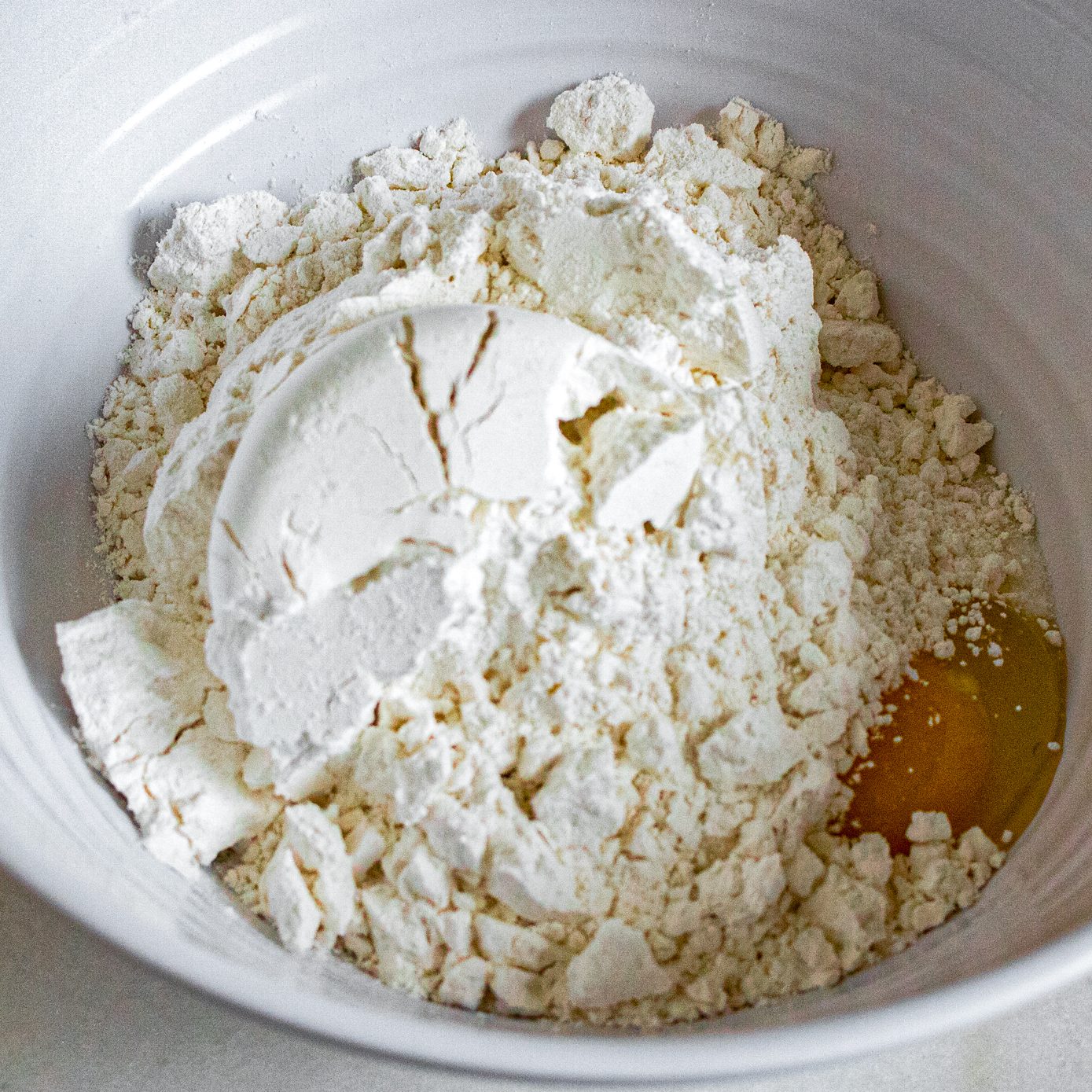 In a medium bowl, combine butter, sugar, egg, and flour. Stir with a spoon for a few moments until the mixture hangs together a bit. Then use hands to form the dough. Pat a bit more than 1/2 of the dough on the bottom and sides of the 9-inch pie dish.