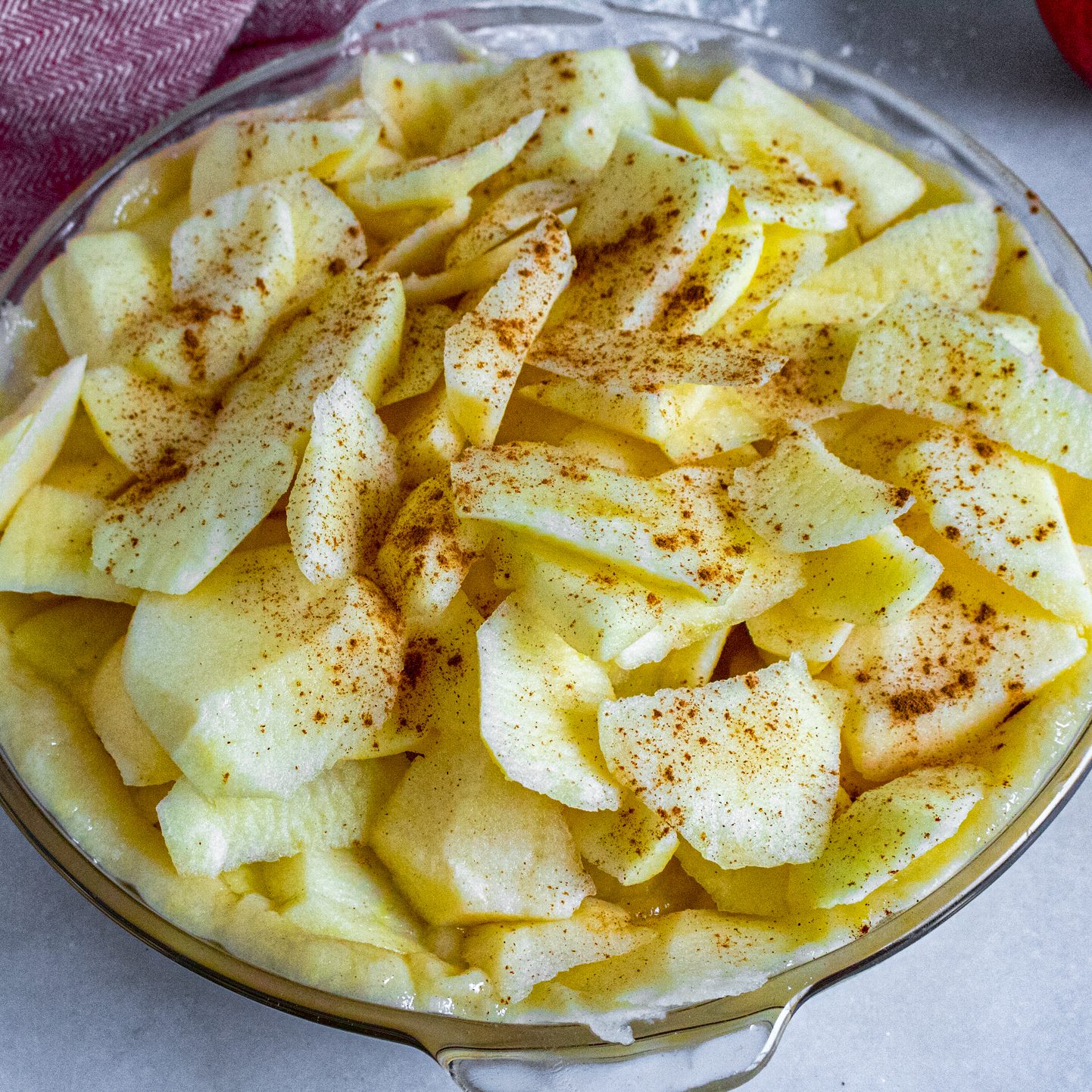 Fill pie shell with apples and dust them with cinnamon. Crumble the rest of the dough over the top of apples until they are more or less covered evenly.