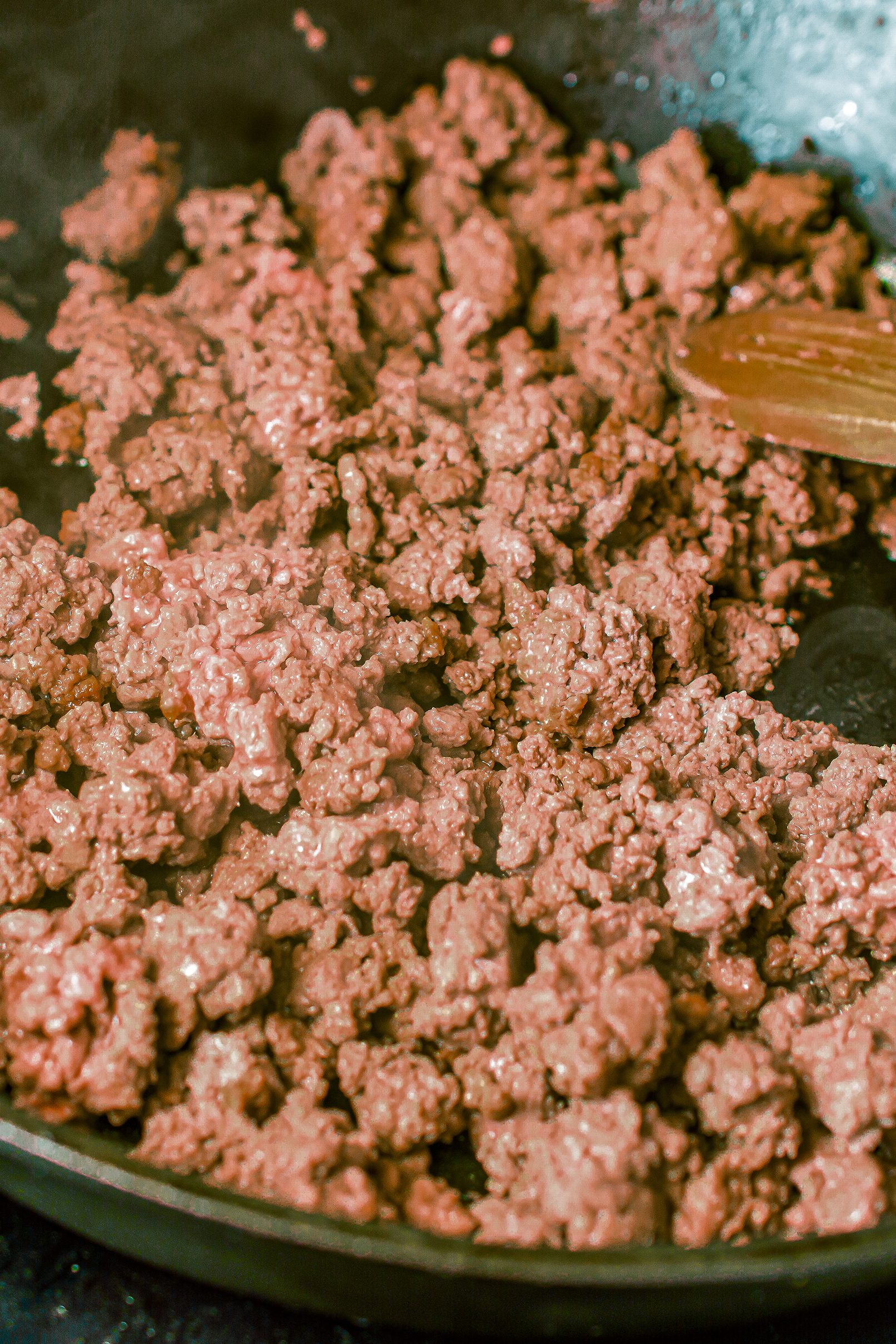 Brown the ground beef in a skillet