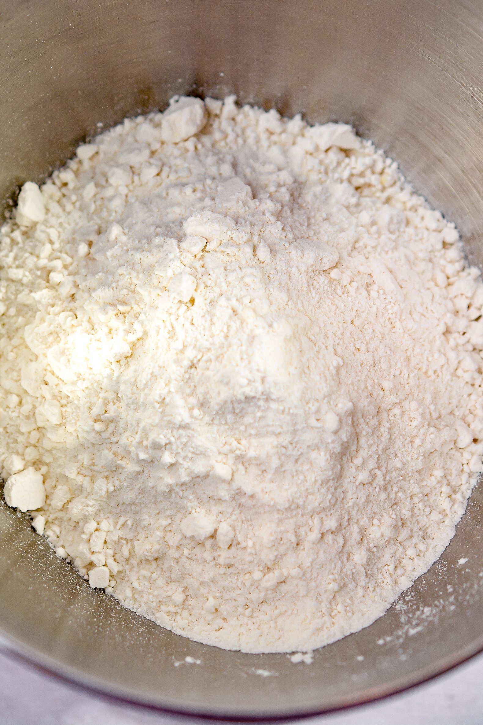 In a mixing bowl, beat together the cake mix, sour cream, oil, eggs, and ¼ cup of milk until smooth.