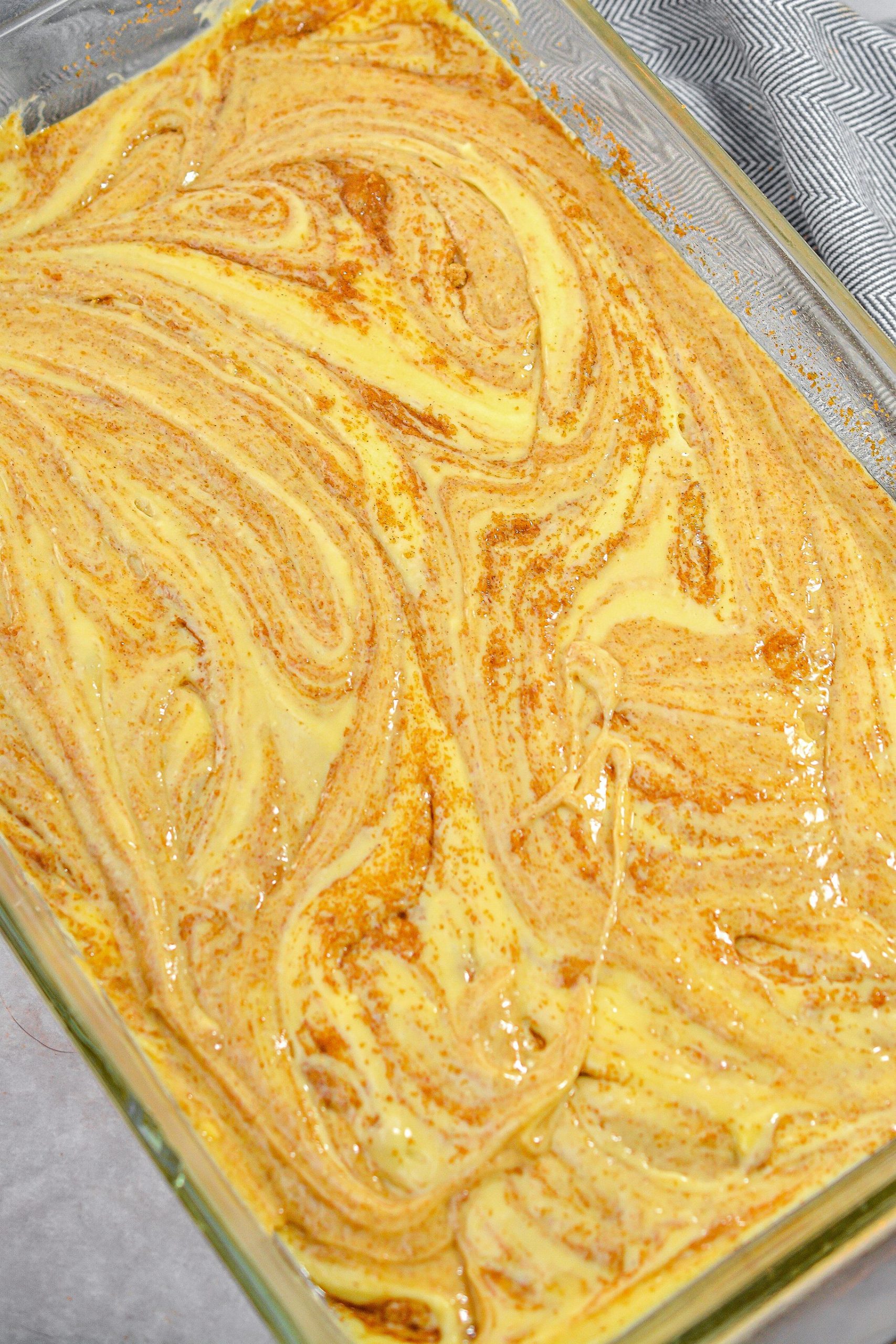 Pour the remaining cake batter into the casserole dish, and swirl to combine the mixture.