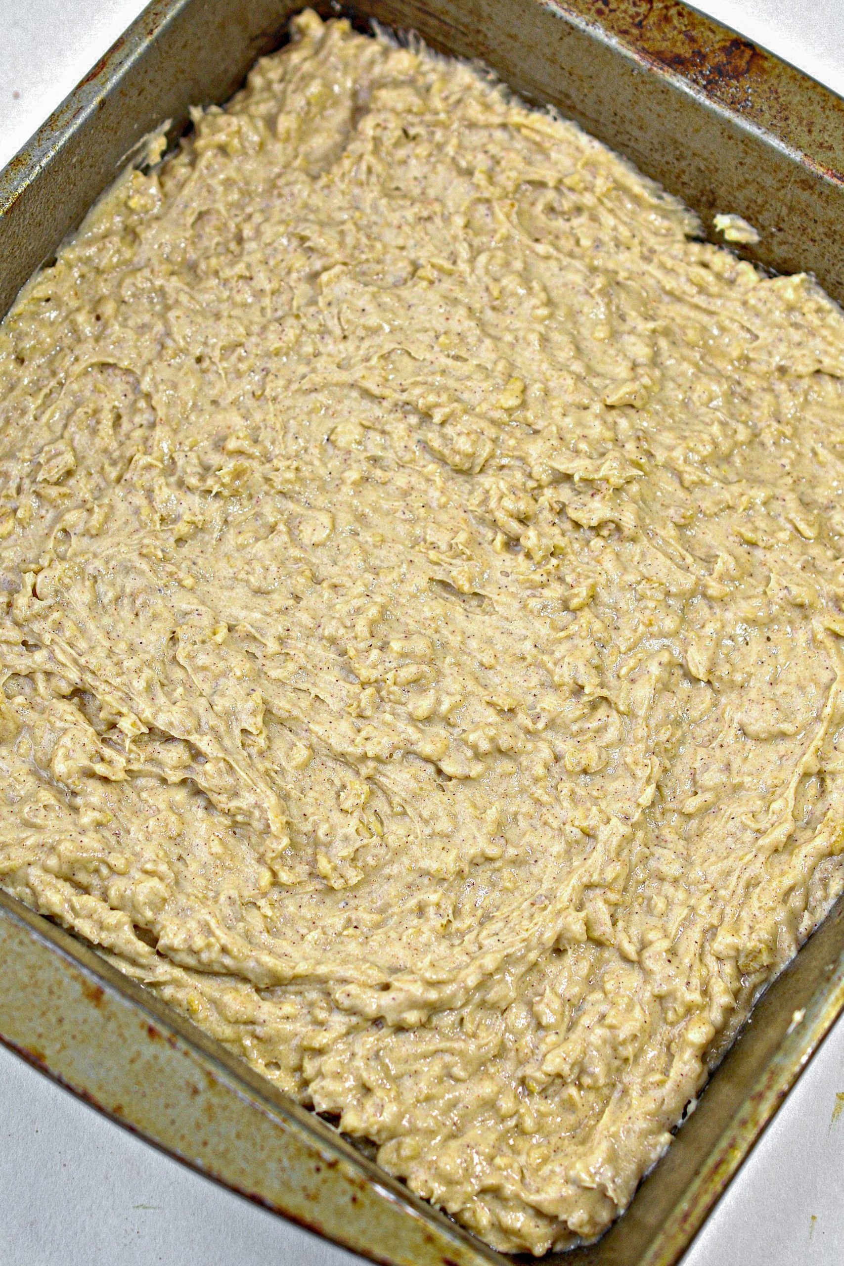 Press the batter mixture in an even layer in the bottom of a 9x9 well-greased baking dish.