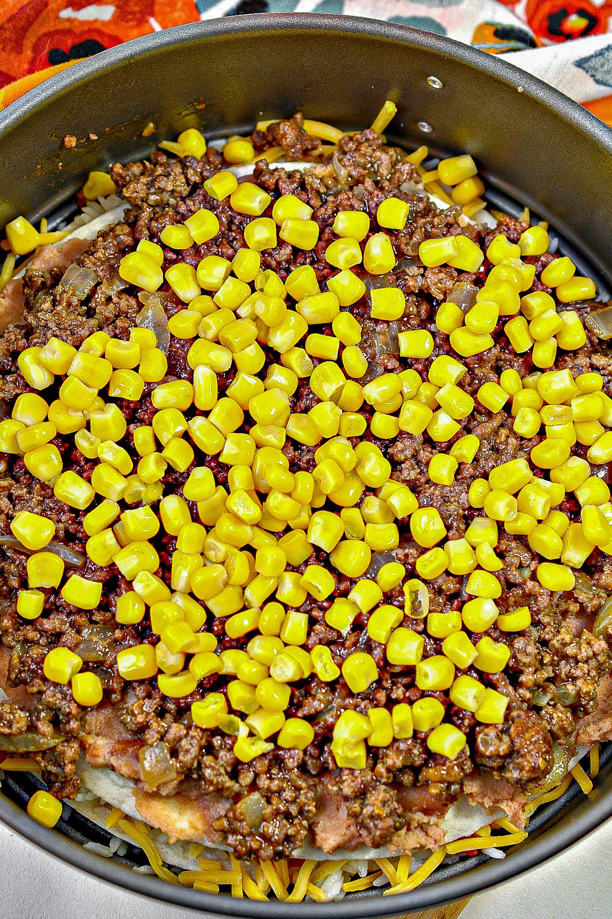 Tortilla, ⅓ of the beans, ½ of the meat, ½ the corn and sprinkling of cheese.
