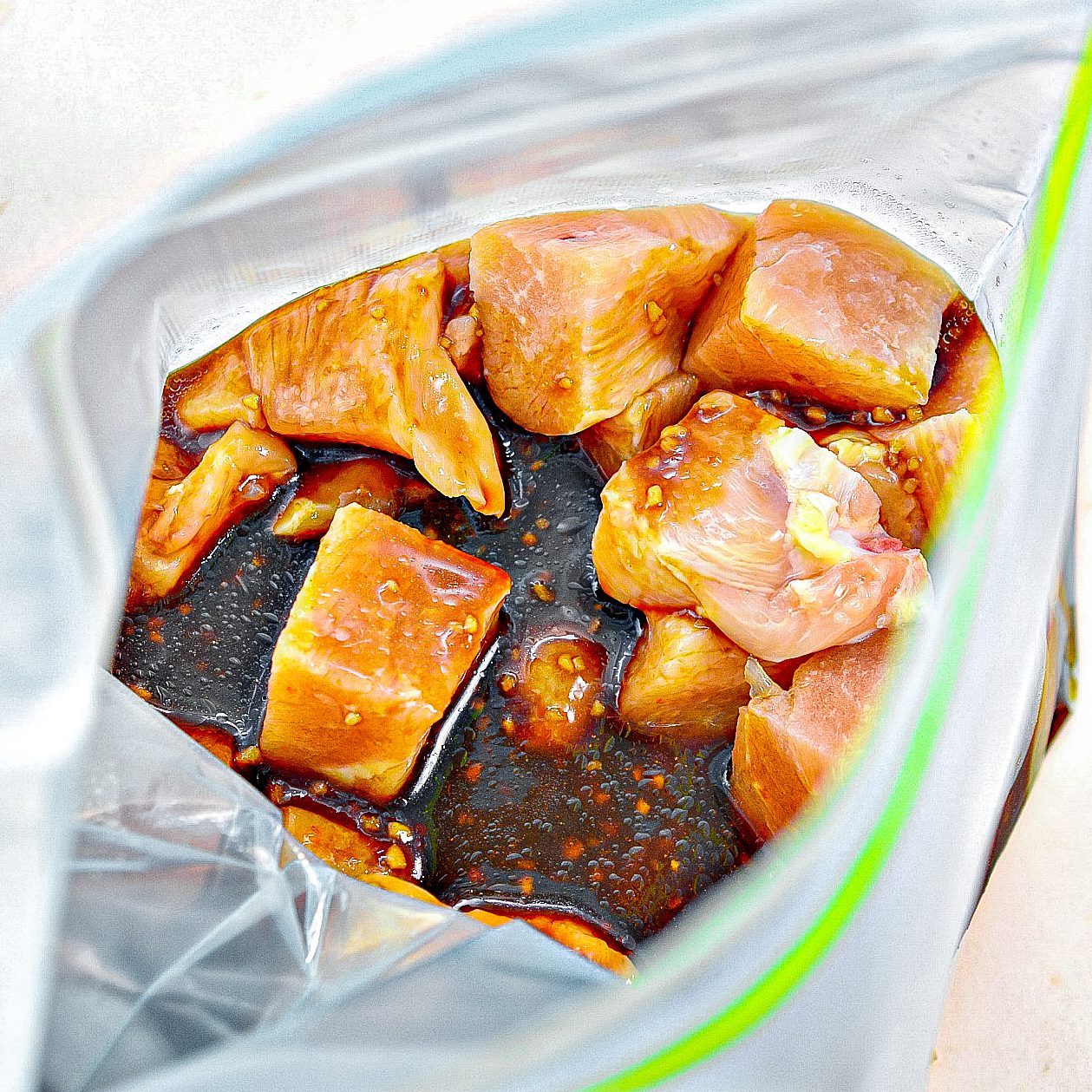 Place the cut-up chicken into a Ziploc bag, and pour the sauce mixture over it. 