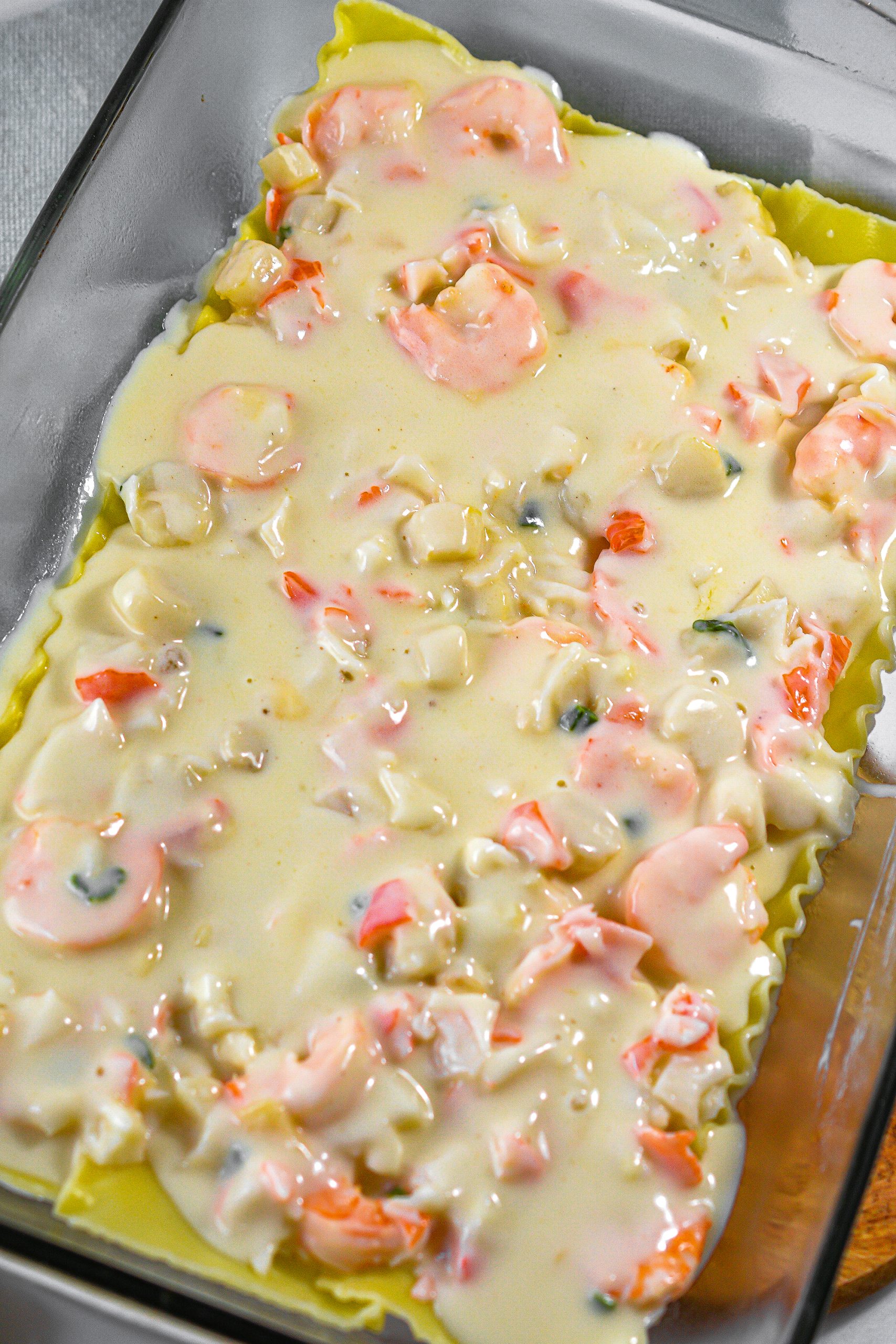 Pour 1 ½ cup sauce over the seafood in the baking dish.