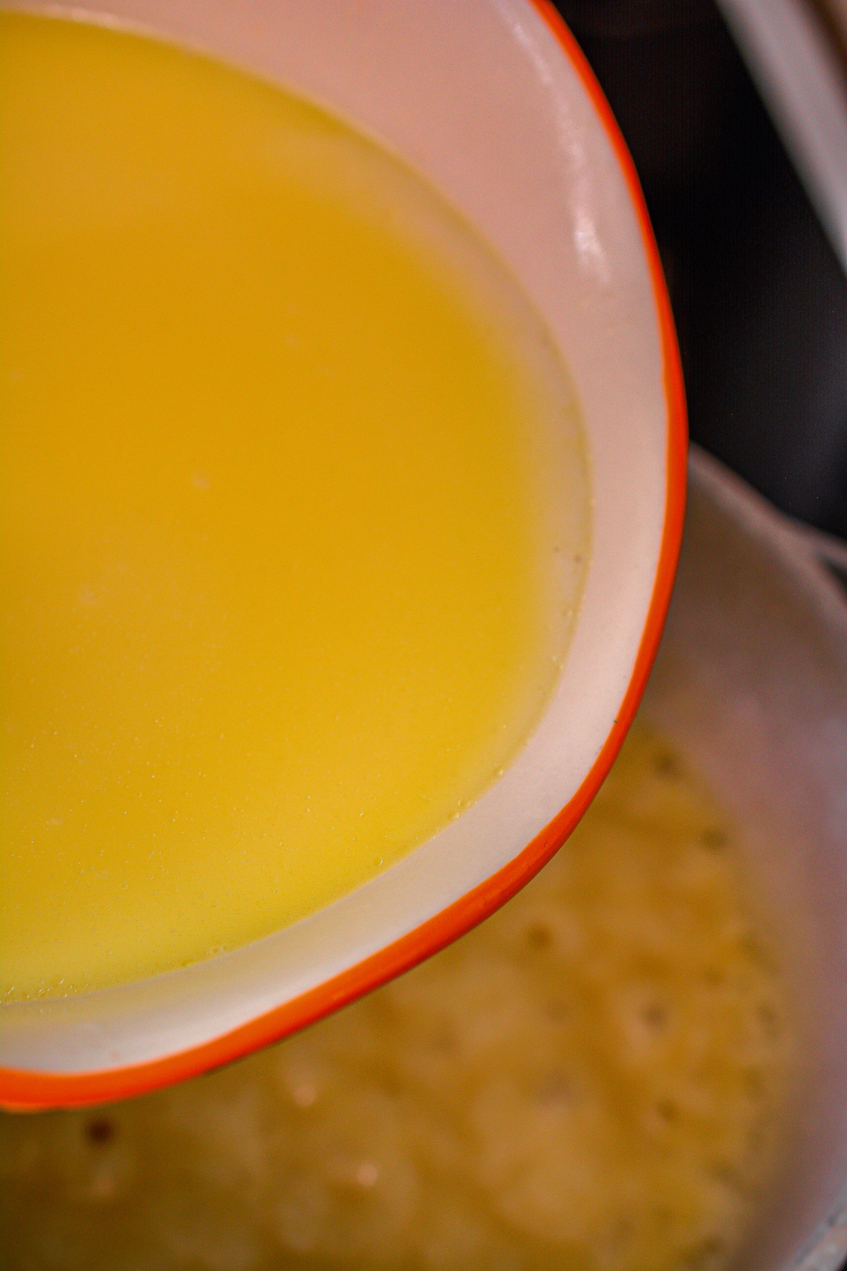 Mix together the milk and reserved cooking liquid. Slowly whisk it into the saucepan.