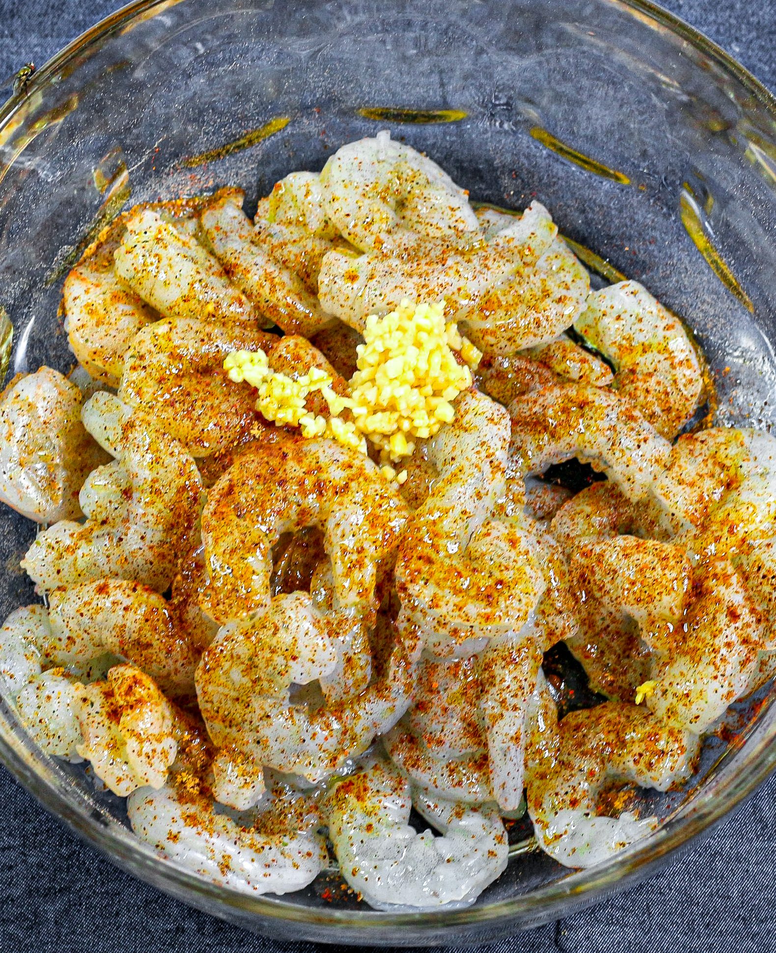 Add the shrimp, 1 TBSP of olive oil, paprika, cumin, chili powder, garlic, and salt to a bowl.